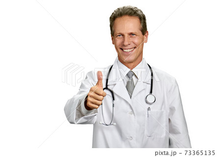 Portrait of cheerful doctor with thumb up gesture. Portrait of cheerful doctor with thumb up gesture. 73365135