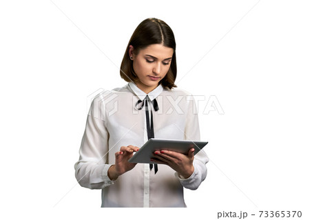 Young business woman working on pc tablet. 73365370