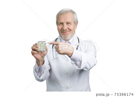 Senior doctor advertising pack of pills. Senior doctor advertising pack of pills. 73366174