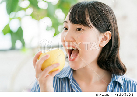 りんごを食べる主婦 73368552