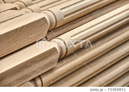 Turning wooden stair balusters. Wood stair balusters stacked in workshop 73369851
