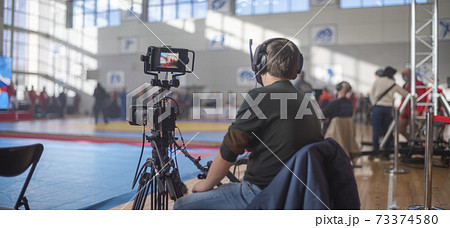 masked operator shoots a stream. Sports event 73374580