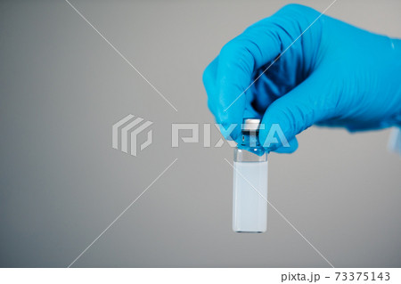 hand holding vaccine bottle for injection medicine hand holding vaccine bottle for injection medicine 73375143