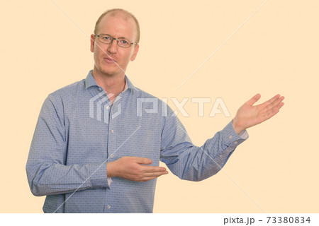 Studio shot of businessman showing something 73380834