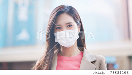 Asian woman with facial mask 73381168