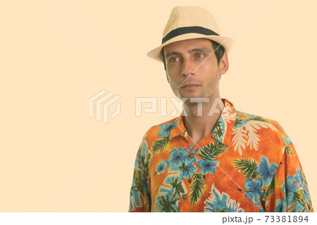 Studio shot of young handsome tourist man thinking ready for vacation 73381894
