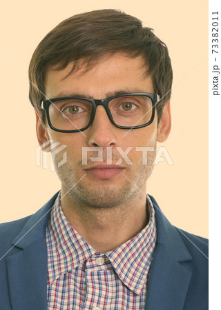 Face of young handsome businessman wearing eyeglasses Face of young handsome businessman wearing eyeglasses 73382011