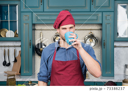 man chef drink tea. Handsome man is holding a cup.  man chef drink tea. Handsome man is holding a cup.  73386237