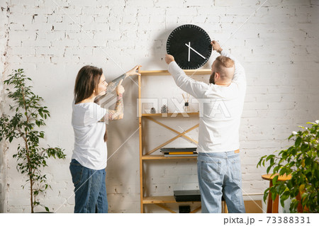 Young family doing apartment repair together themselves. Married man and woman doing home makeover or renovation 73388331