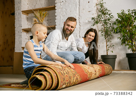 Young family doing apartment repair together themselves. Mother, father and son doing home makeover or renovation 73388342