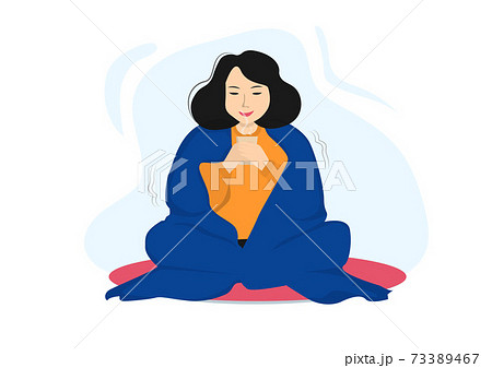 A woman happy to relax, drink tea, cover her body with a blanket. 73389467