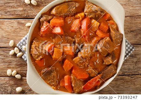 Recipe Mafe or Maafe West African meat in peanut sauce closeup in the pan. horizontal top view Recipe Mafe or Maafe West African meat in peanut sauce closeup in the pan. horizontal top view 73393247