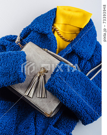 Yellow turtle neck with gray handbag, blue coat Yellow turtle neck with gray handbag, blue coat 73393948