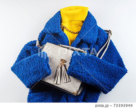 Yellow turtle neck with gray handbag, blue coat Yellow turtle neck with gray handbag, blue coat 73393949