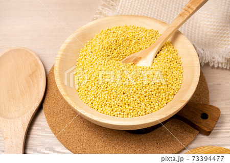 Raw millet groats on wooden background. space for text 73394477