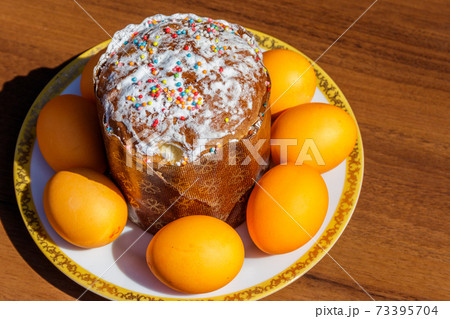 Easter cake and painted eggs on a table Easter cake and painted eggs on a table 73395704