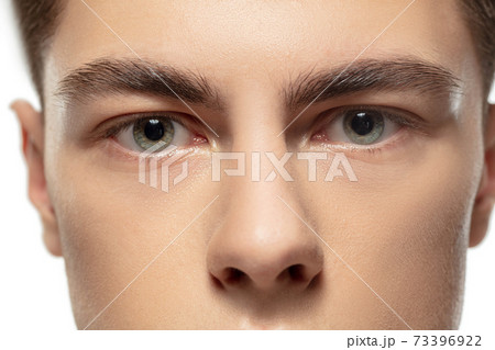 Close up face of young man isolated on white studio background. Caucasian attractive male model. Concept of fashion and beauty, self-care, body and skin care. 73396922