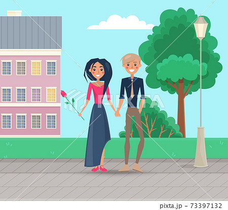 Couple walking by the handle in city park. Girl with a red tulip on date with her boyfriend outdoors 73397132