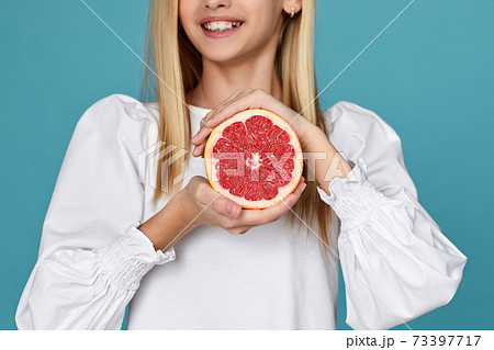 cute little child girl holding fresh juicy grapefruit cute little child girl holding fresh juicy grapefruit 73397717