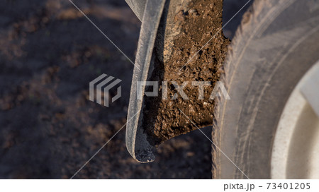 dirty car mudguard on the rear wheel splashed with a wet swamp close-up, traveling along a rural field road to a suv 4x4, nobody. dirty car mudguard on the rear wheel splashed with a wet swamp close-up, traveling along a rural field road to a suv 4x4, nobody. 73401205