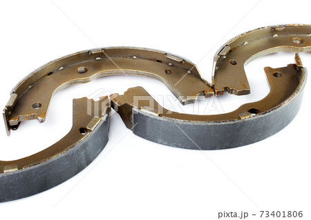 kit of four drum brake shoes with asbestos alloy on steel car spare parts pads close up isolated on white background, nobody. 73401806