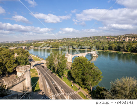 Avignon, famous bridge with Rhone river against blue sky in Provence, France Avignon, famous bridge with Rhone river against blue sky in Provence, France 73403243