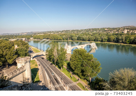 Avignon, famous bridge with Rhone river against blue sky in Provence, France Avignon, famous bridge with Rhone river against blue sky in Provence, France 73403245