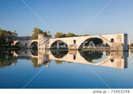 Avignon, famous bridge with Rhone river against blue sky in Provence, France 73403248