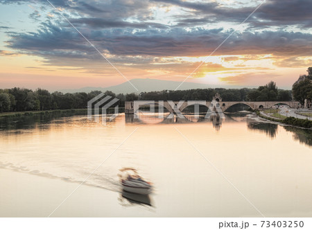 Avignon, famous bridge with Rhone river against sunset in Provence, France 73403250