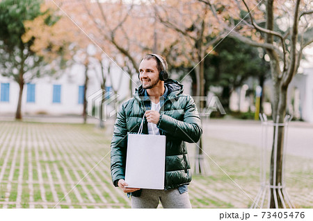 man holding White paper bag and white t-shirt mockup 73405476