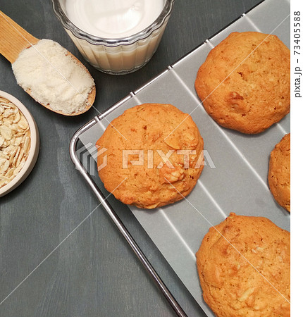 Freshly baked oatmeal cookies on cooling rack over gray wood Freshly baked oatmeal cookies on cooling rack over gray wood 73405588