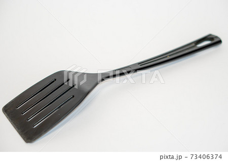 Black plastic kitchen spatula isolated on white background 73406374