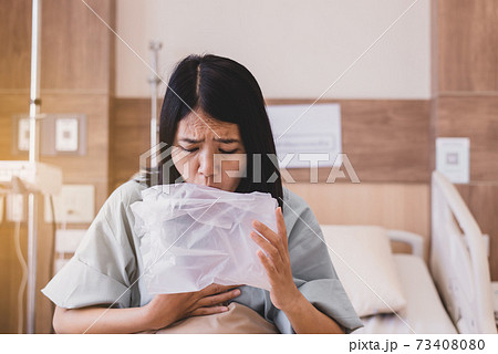 Asian women patient puke or vomiting into plastic bag at hospital,Nausea,Indigestible Asian women patient puke or vomiting into plastic bag at hospital,Nausea,Indigestible 73408080