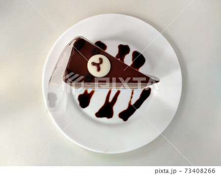 Delicious chocolate cake on plate on table 73408266
