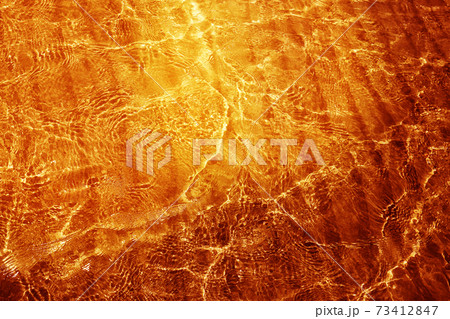 Photo background macro of transparent golden water 73412847