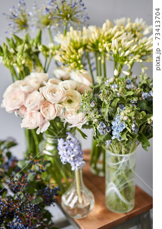 Set of white and blue flowers for Interior decorations. The work of the florist at a flower shop. Fresh cut flower. European floral shop. Delivery fresh cut flower 73413704