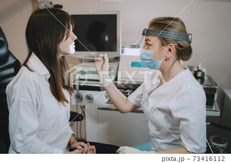 Otolaryngologist preparing for the medical examination procedure Otolaryngologist preparing for the medical examination procedure 73416112