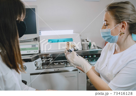 Otolaryngologist preparing for the medical examination procedure Otolaryngologist preparing for the medical examination procedure 73416128