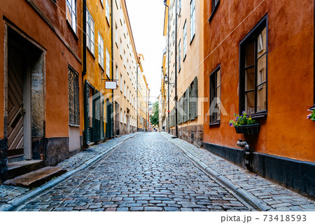 Beautiful old cobblestoned street amidst old colorful houses in Gamla Stan in Stockholm 73418593