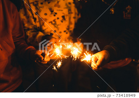 party with friends holding Sparklers party with friends holding Sparklers 73418949