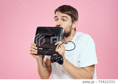 Man with prefix in hand joystick games lifestyle fun pink background white t-shirt 73422331