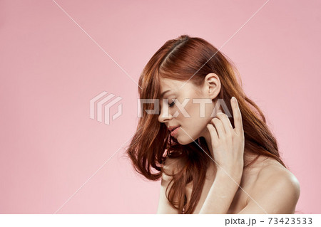 Pretty woman with long beautiful hair grooming hairstyle glamor naked shoulders pink background 73423533