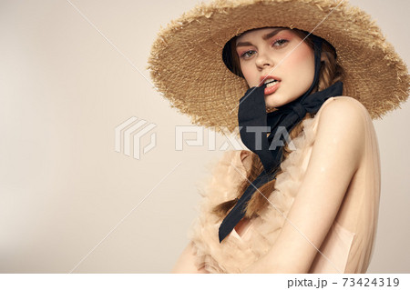 cute girl in straw hat with black ribbon and dress on beige background cropped view cute girl in straw hat with black ribbon and dress on beige background cropped view 73424319