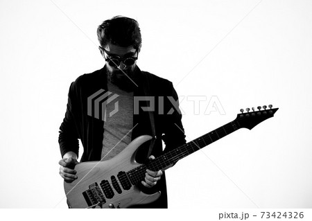 man with guitar in hands musician rock star performance lifestyle light background man with guitar in hands musician rock star performance lifestyle light background 73424326