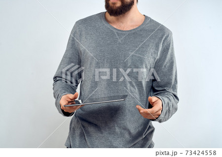 Man with tablet in hands technology lifestyle internet communication work light background cropped view 73424558