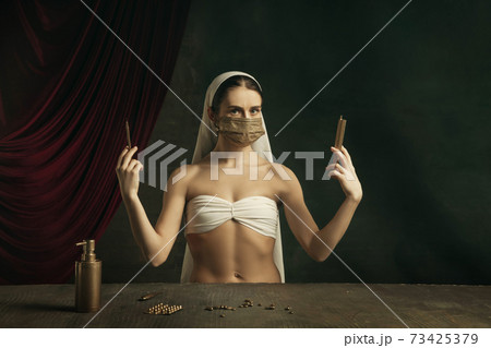 Modern remake of classical artwork with coronavirus theme - young medieval woman on dark background Modern remake of classical artwork with coronavirus theme - young medieval woman on dark background 73425379