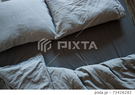 Blue bed sheets and pillows after night's sleep. Blue bed sheets and pillows after night's sleep. 73426282