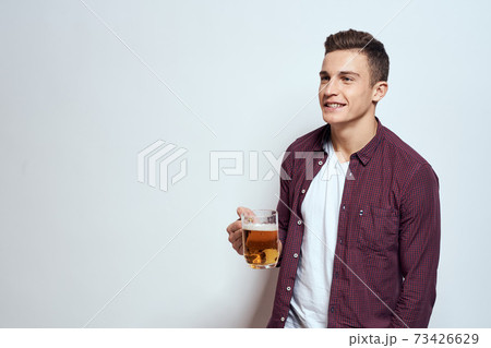 Man with a mug of beer fun alcohol lifestyle shirt light background 73426629