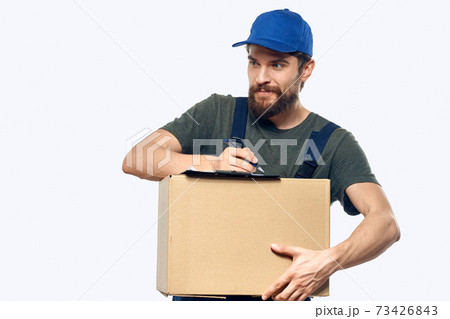 Working male courier with box in hand documents delivery service light background Working male courier with box in hand documents delivery service light background 73426843