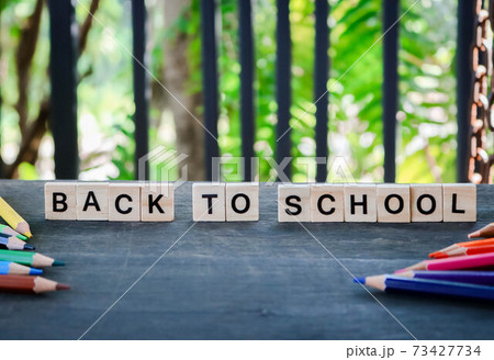 Word tiles the word " back to school " Text dice cube concept / Letter and Color pencils isolated on wooden black background. Block of alphabet studded on the floor. colorful. Word tiles the word " back to school " Text dice cube concept / Letter and Color pencils isolated on wooden black background. Block of alphabet studded on the floor. colorful. 73427734